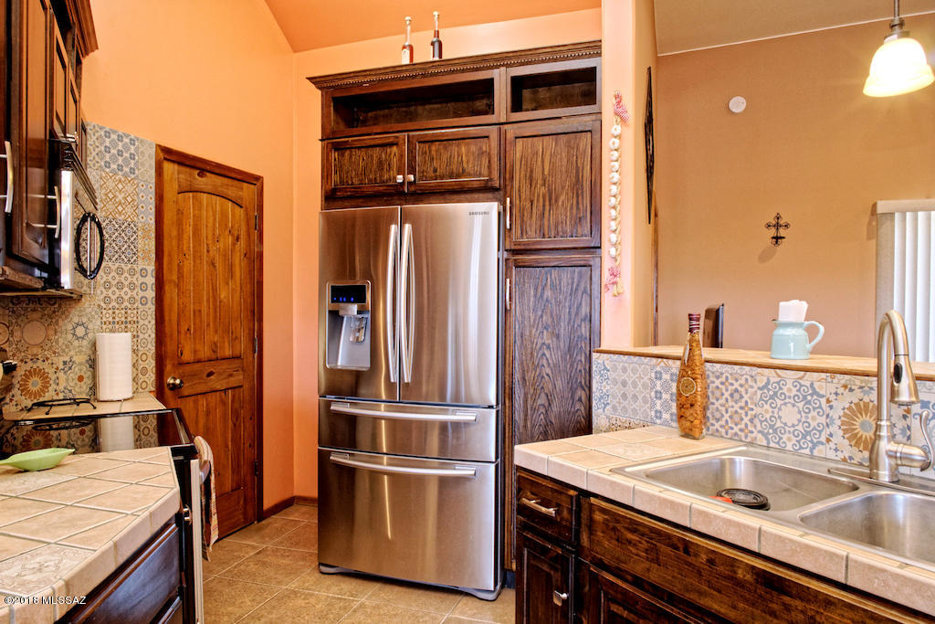 1721 Camino Jalisco Rio Rico, AZ 85648 - Photo 8 of 39 a kitchen with stainless steel appliances granite countertop a sink and a refrigerator