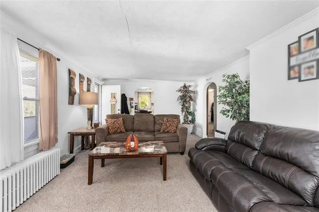 a living room with furniture and a lamp