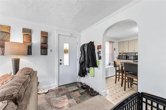 a kitchen with a table chairs sink and refrigerator
