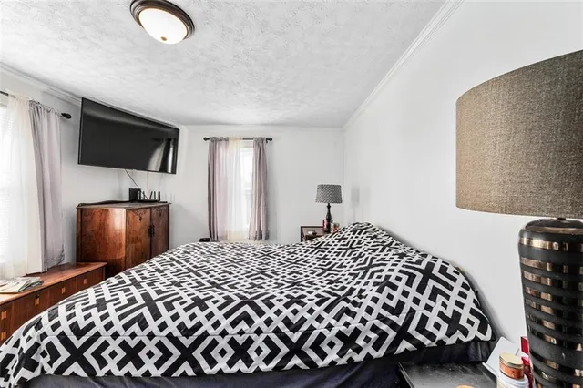 a bedroom with a bed and a mirror