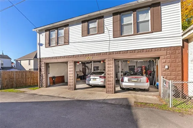 a view of a building with car parked on the road