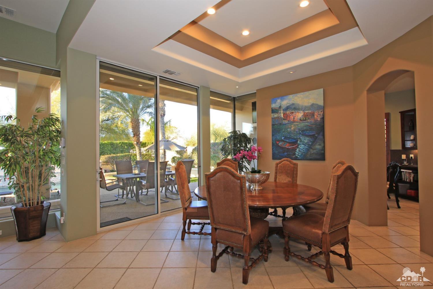 250 Loch Lomond Road Rancho Mirage, CA 92270 - Photo 12 of 33 a dining room with furniture and a floor to ceiling window