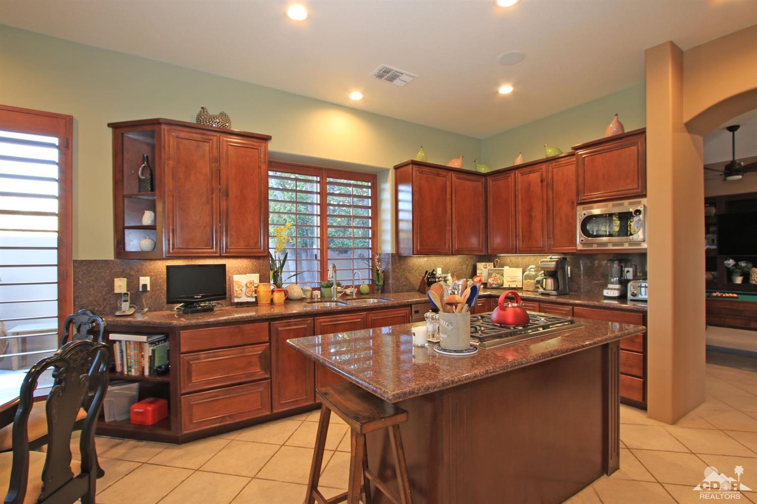 250 Loch Lomond Road Rancho Mirage, CA 92270 - Photo 14 of 33 a kitchen with stainless steel appliances granite countertop a sink counter space and cabinets