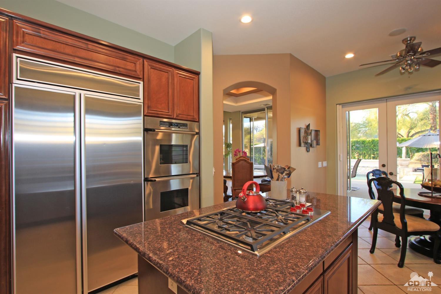 250 Loch Lomond Road Rancho Mirage, CA 92270 - Photo 16 of 33 a kitchen with a refrigerator and a table