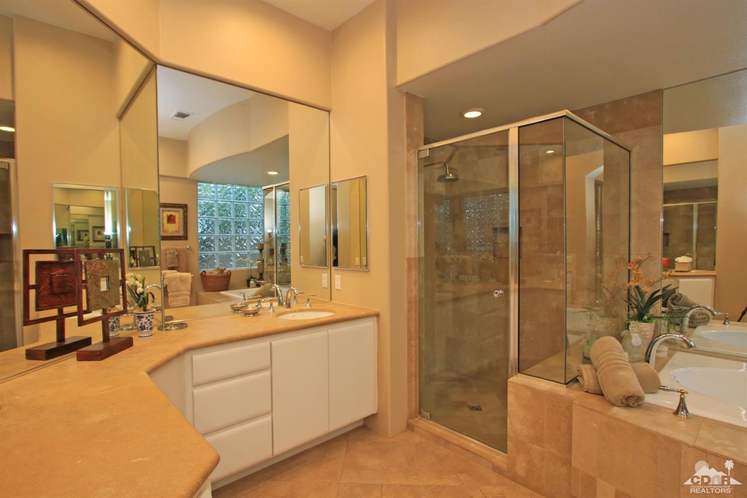 250 Loch Lomond Road Rancho Mirage, CA 92270 - Photo 20 of 33 a bathroom with a double vanity sink a mirror and a shower