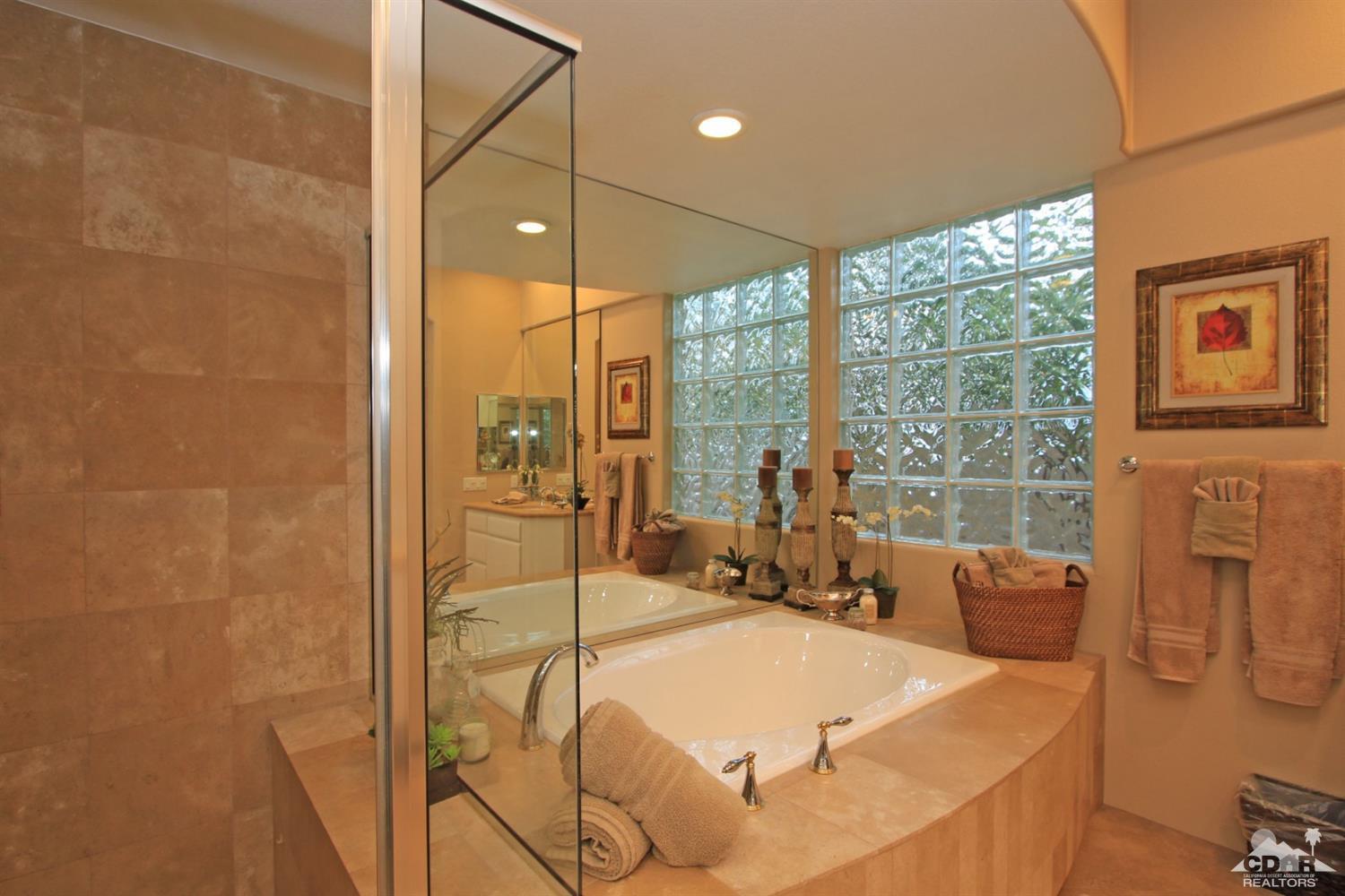 250 Loch Lomond Road Rancho Mirage, CA 92270 - Photo 21 of 33 a bed sitting in a bedroom next to a window