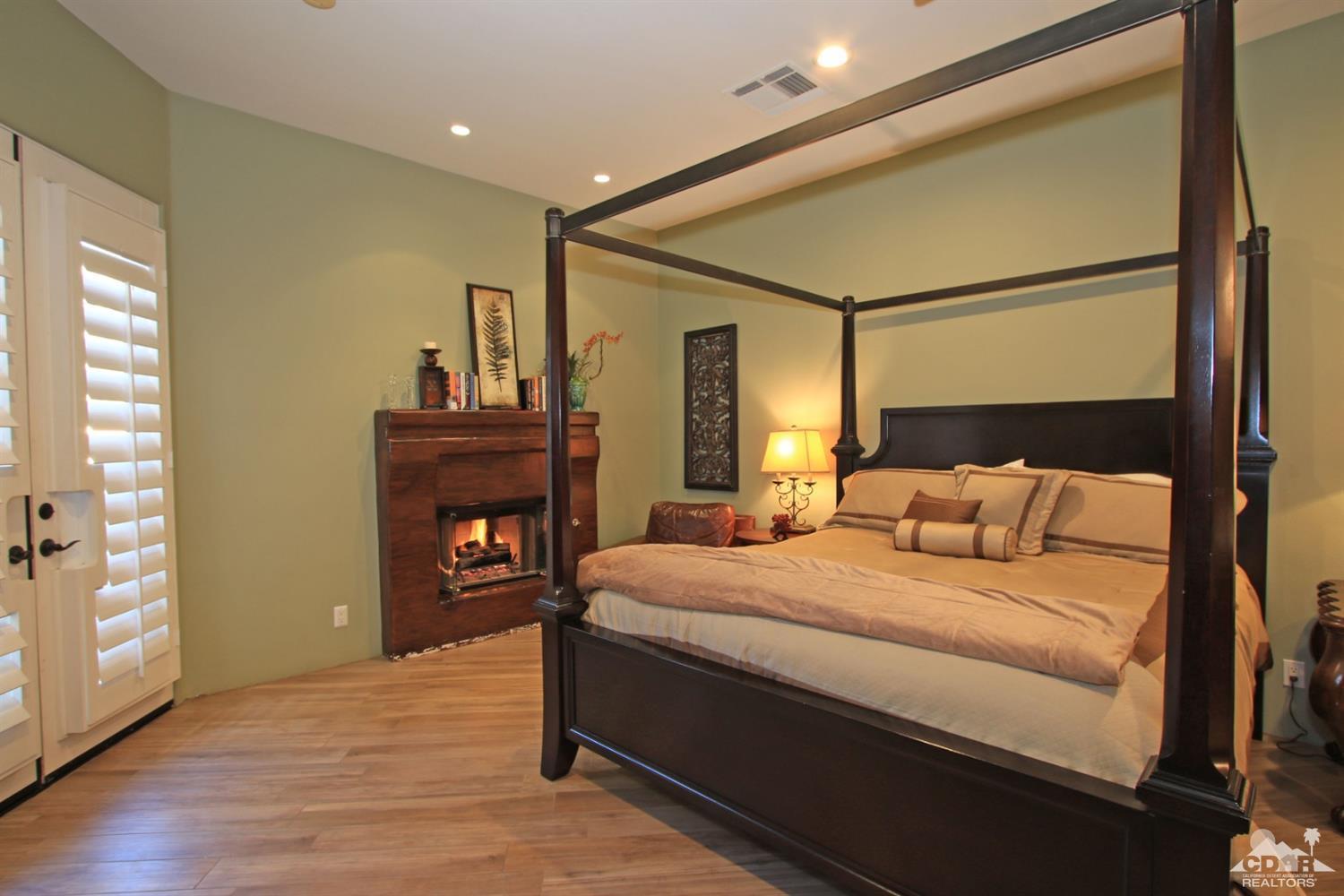 250 Loch Lomond Road Rancho Mirage, CA 92270 - Photo 22 of 33 a bedroom with a bed and wooden floor