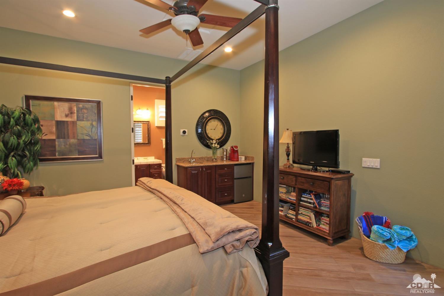250 Loch Lomond Road Rancho Mirage, CA 92270 - Photo 23 of 33 a bedroom with a bed and a flat tv screen on dresser