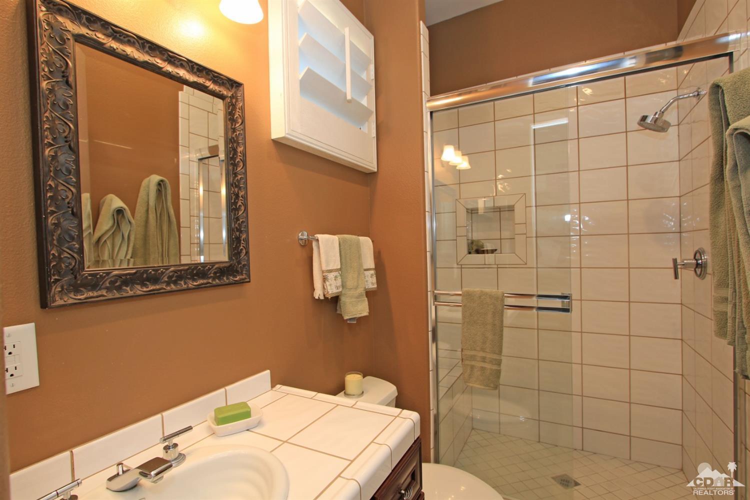 250 Loch Lomond Road Rancho Mirage, CA 92270 - Photo 24 of 33 a bathroom with a sink and mirror