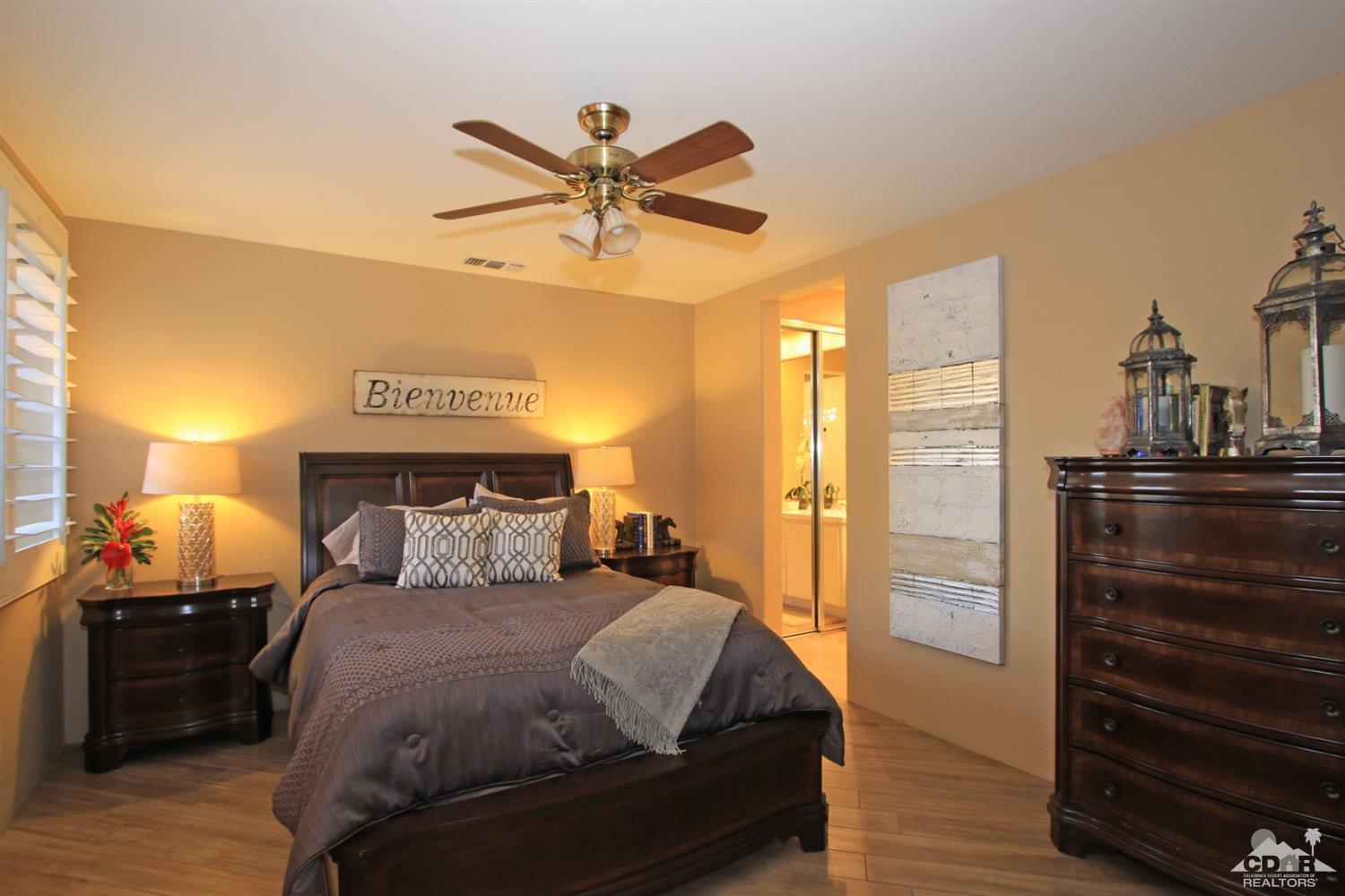 250 Loch Lomond Road Rancho Mirage, CA 92270 - Photo 26 of 33 a bedroom with a bed and wooden floor