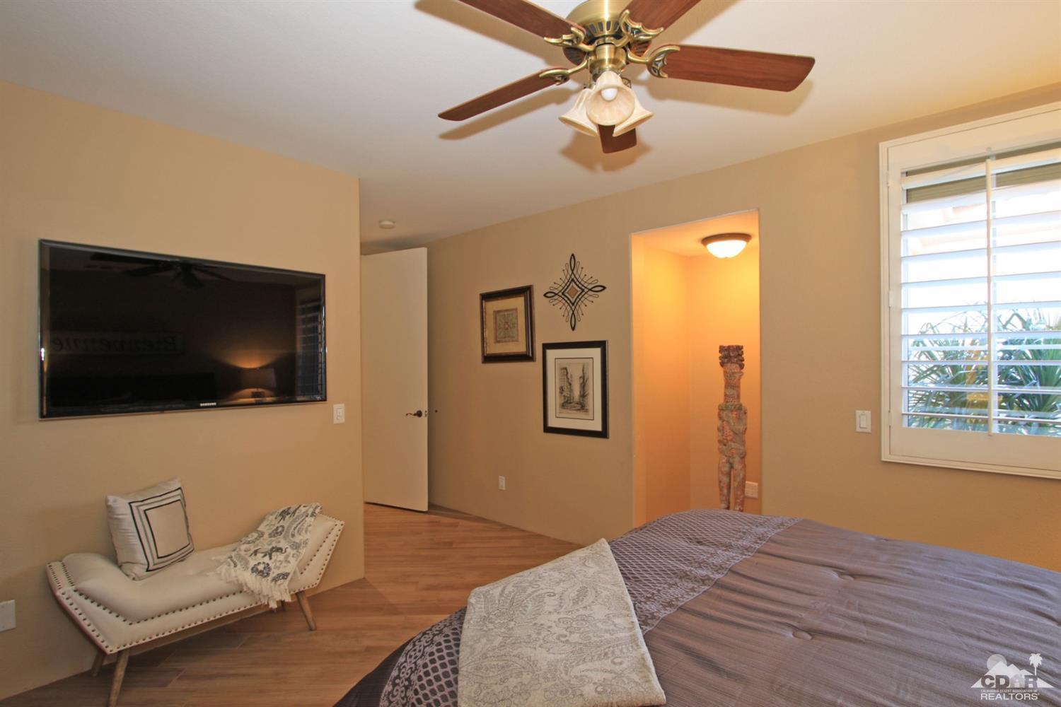 250 Loch Lomond Road Rancho Mirage, CA 92270 - Photo 27 of 33 a bedroom with a bed and a flat screen tv