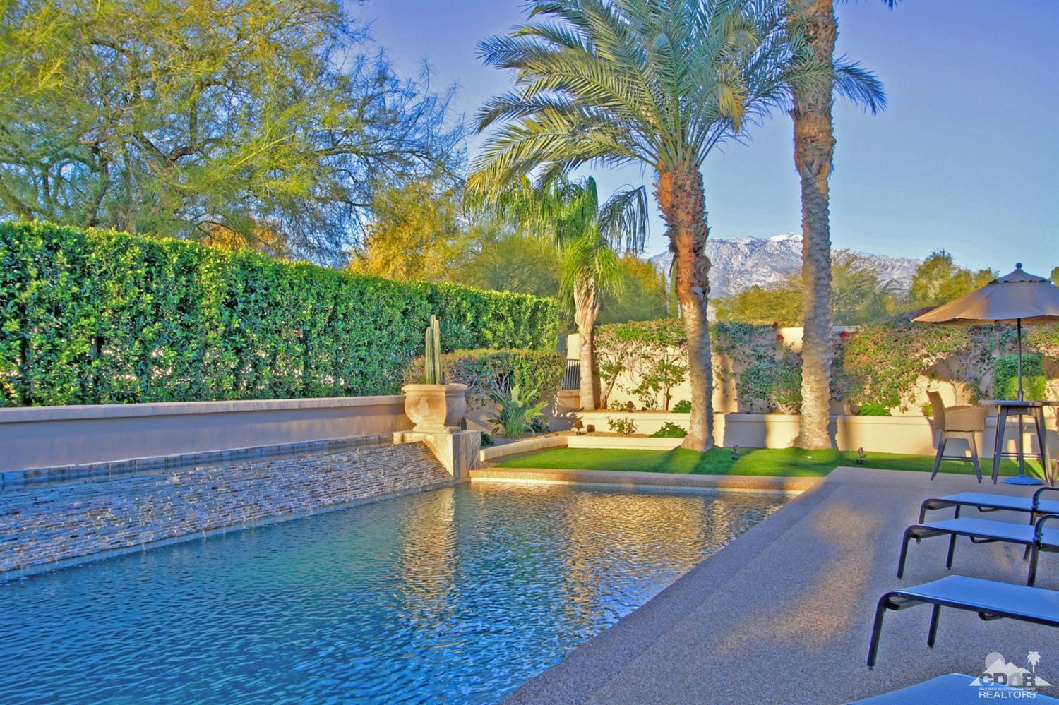 250 Loch Lomond Road Rancho Mirage, CA 92270 - Photo 28 of 33 a view of swimming pool with outdoor seating and trees in the background