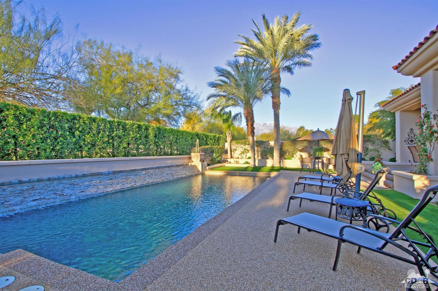 250 Loch Lomond Road Rancho Mirage, CA 92270 - Photo 33 of 33 a view of swimming pool with outdoor seating and trees in the background