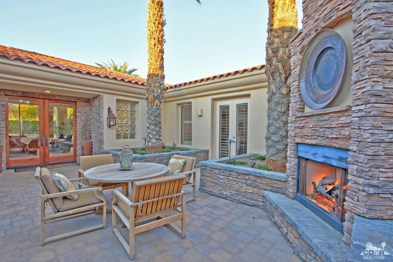 250 Loch Lomond Road Rancho Mirage, CA 92270 - Photo 7 of 33 a outdoor space with patio the couches and a fireplace