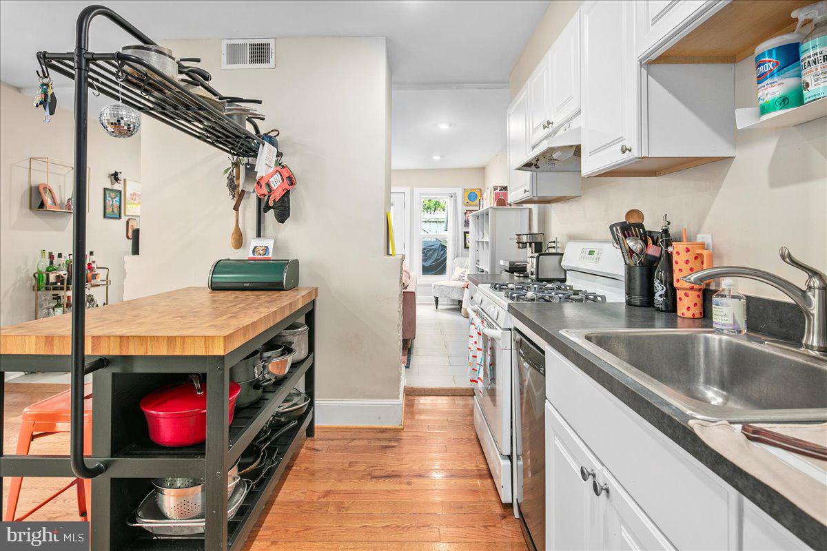304 2nd Street Southeast Washington, DC 20003 - Photo 11 of 70 a kitchen with stainless steel appliances granite countertop a sink stove and refrigerator