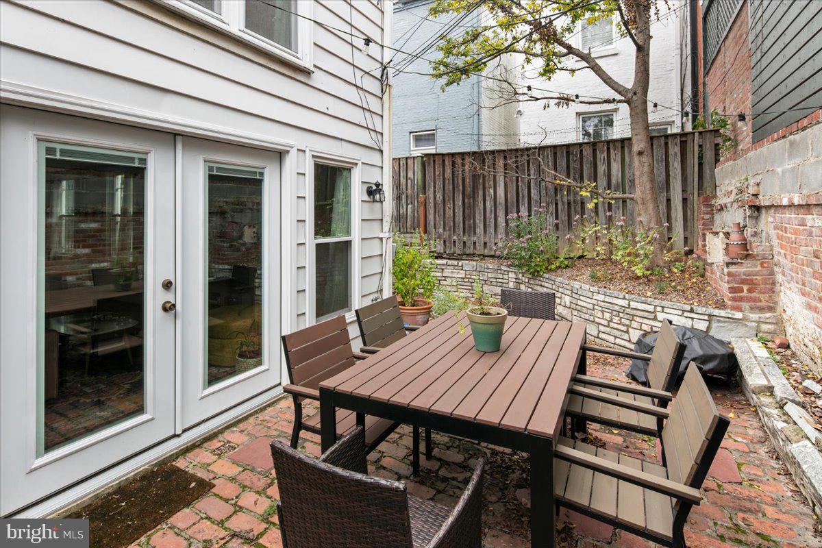 304 2nd Street Southeast Washington, DC 20003 - Photo 24 of 70 a view of a patio with table and chairs with wooden floor and fence