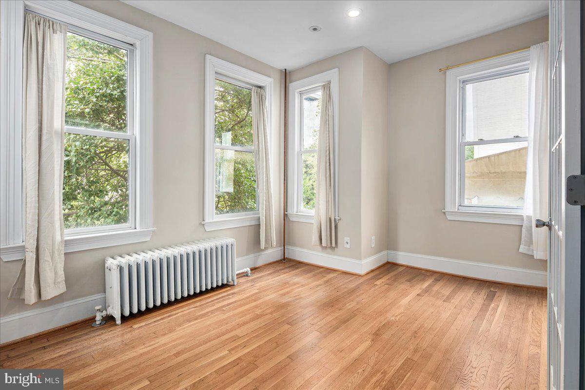 304 2nd Street Southeast Washington, DC 20003 - Photo 32 of 70 a view of an empty room with wooden floor and a window