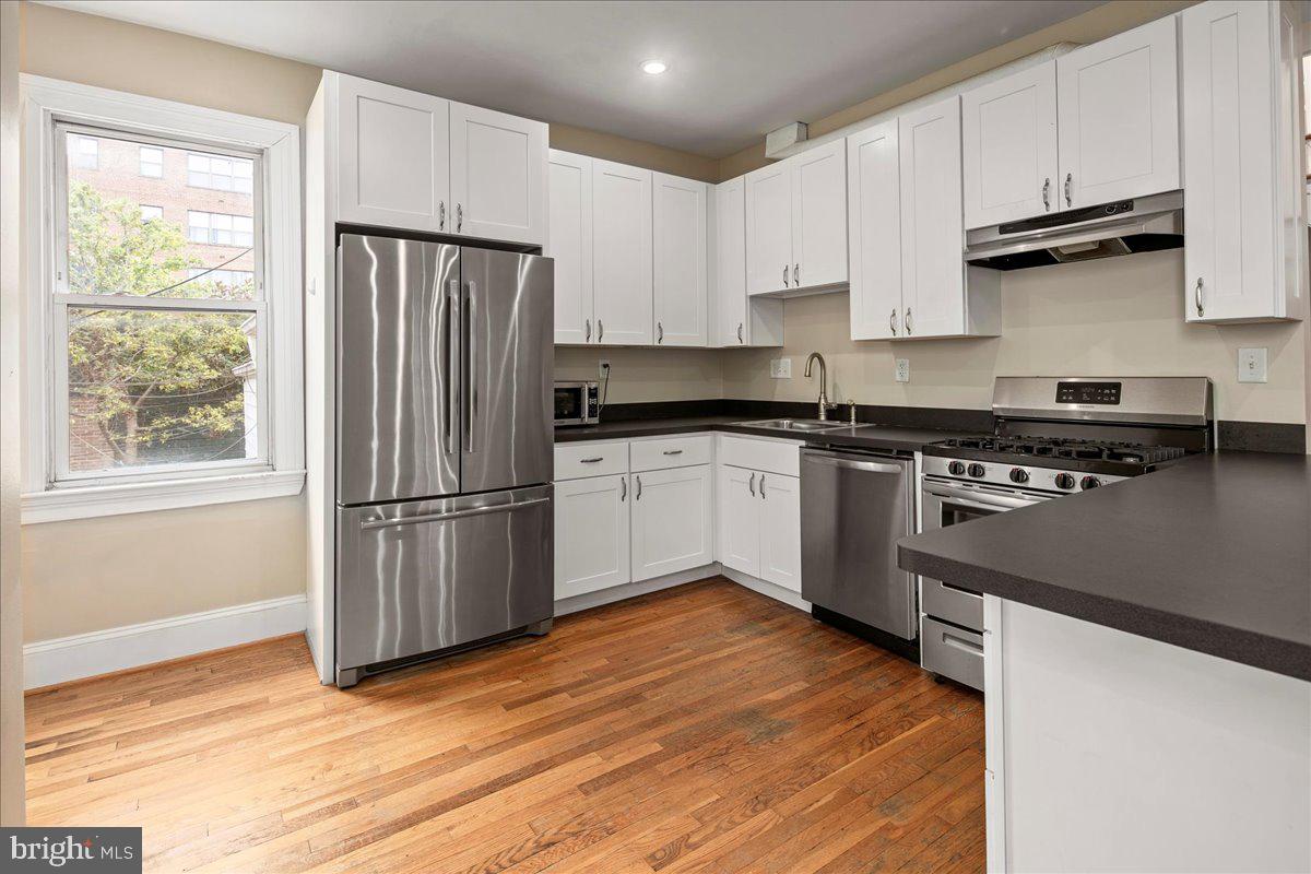 304 2nd Street Southeast Washington, DC 20003 - Photo 38 of 70 a kitchen with granite countertop a refrigerator stove top oven and sink