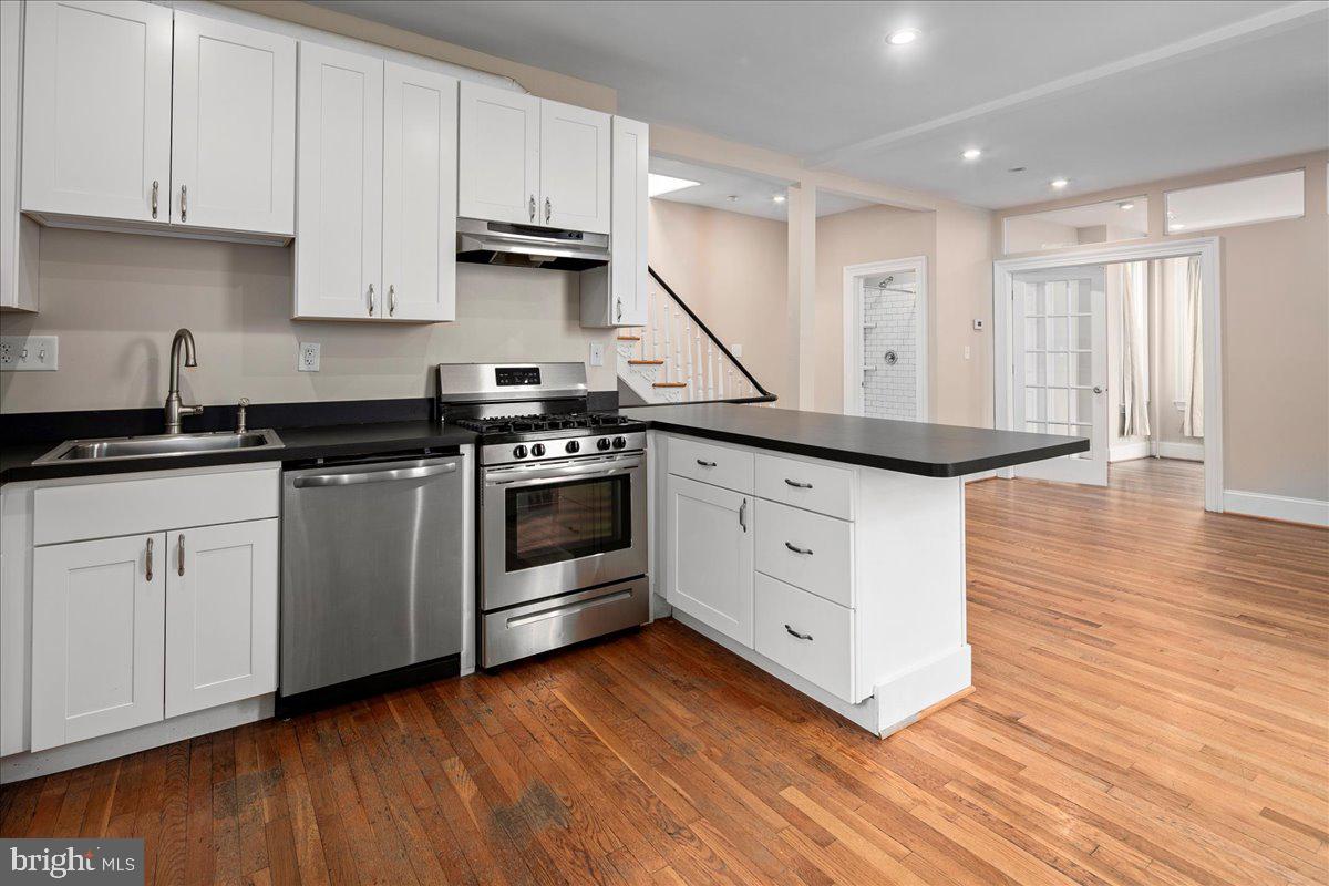 304 2nd Street Southeast Washington, DC 20003 - Photo 40 of 70 a kitchen with stainless steel appliances granite countertop a stove a sink and white cabinets