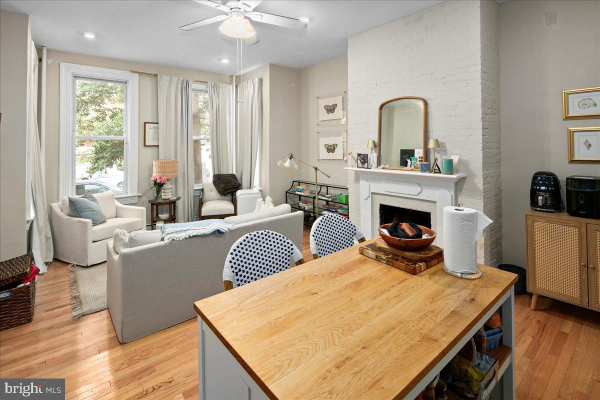 304 2nd Street Southeast Washington, DC 20003 - Photo 64 of 70 a living room with furniture a fireplace and a floor to ceiling window