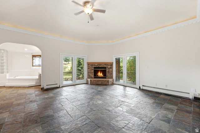 3535 Homestead Road Park City, UT 84098 - Photo 26 of 81 Spacious room featuring slate tile flooring, a corner brick fireplace, and two sets of glass-paned French doors