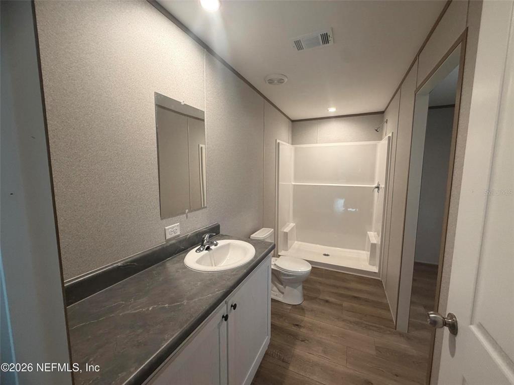 114 Nutmeg Trail Interlachen, FL 32148 - Photo 9 of 33 a bathroom with a granite countertop sink toilet and shower