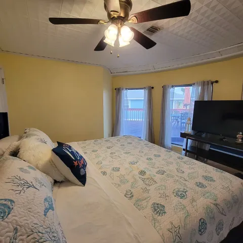 a bedroom with a bed and a flat screen tv