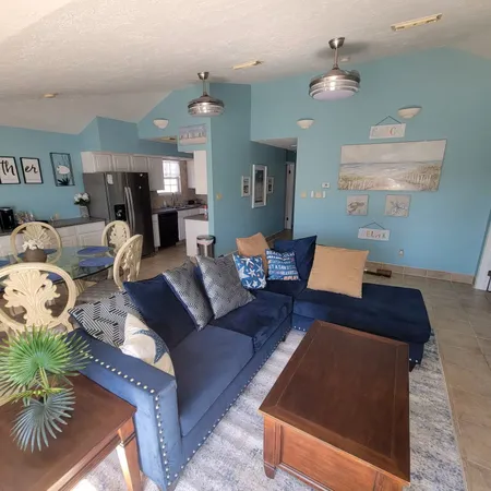 a living room with furniture and a lamp