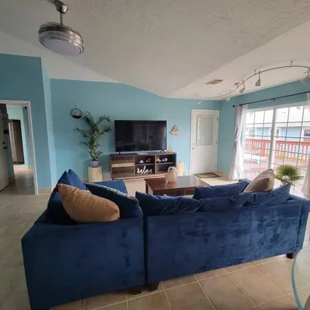 a living room with furniture and a flat screen tv