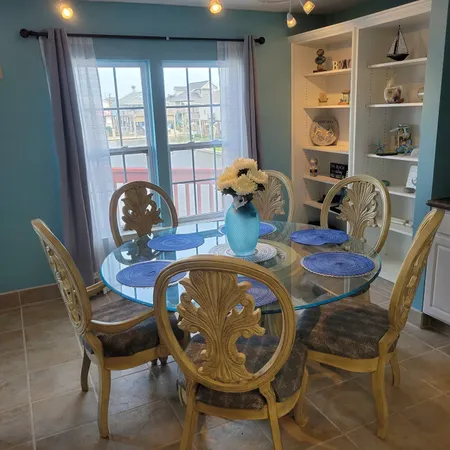 a dining room with furniture and window