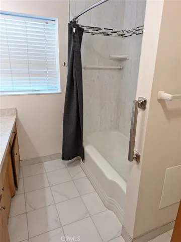 a bathroom with a bath tub and a shower