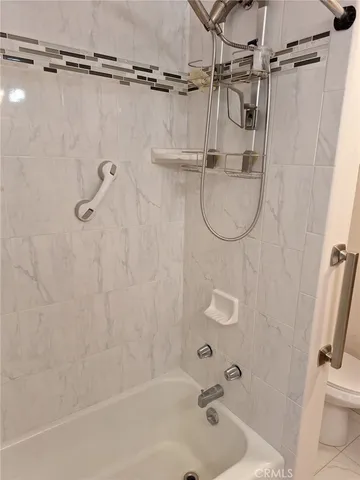 a bathroom with a bath tub with a shower