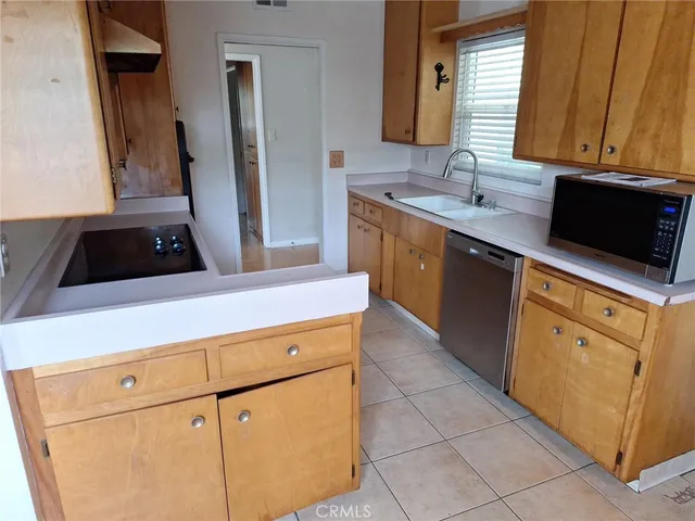 a kitchen with a sink and a refrigerator