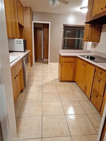 a view of a kitchen with fridge and sink