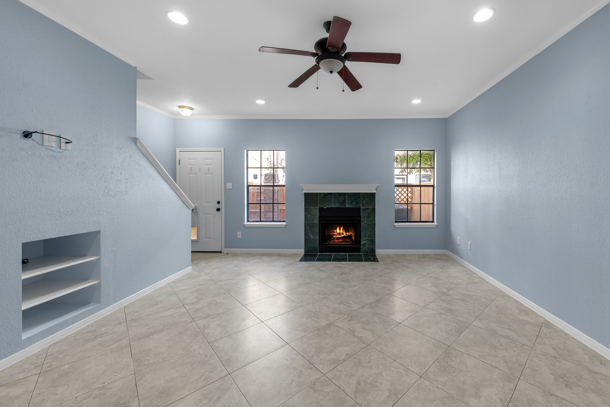 9800 Pagewood Lane, Unit 3103 Houston, TX 77063 - Photo 11 of 27 a view of empty room with a fireplace and windows