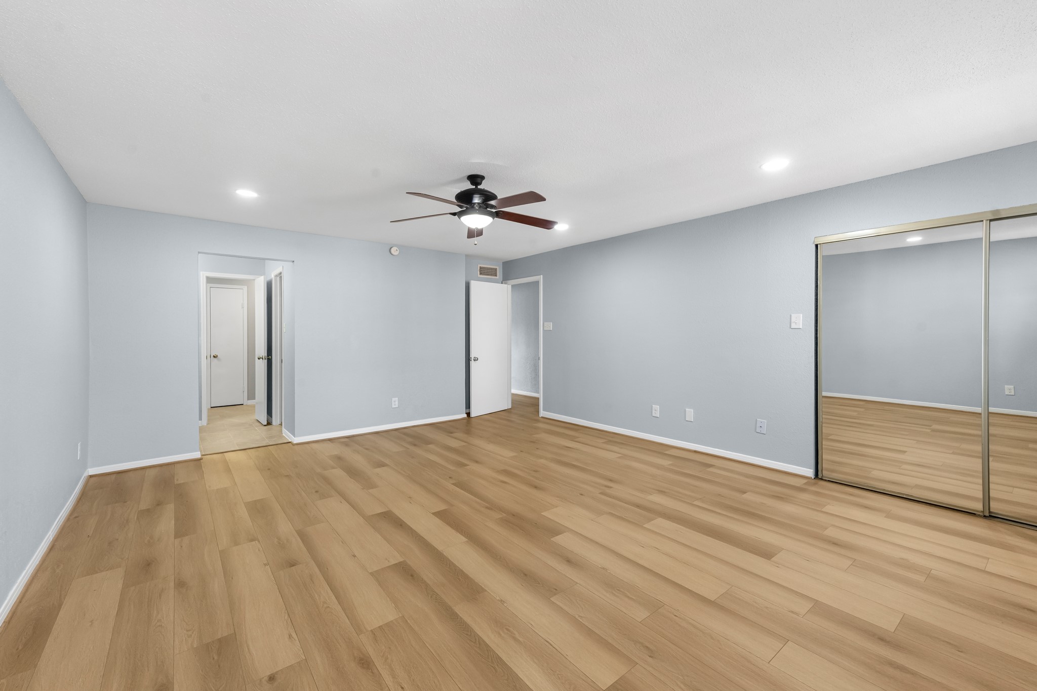 9800 Pagewood Lane, Unit 3103 Houston, TX 77063 - Photo 19 of 27 a view of empty room with wooden floor