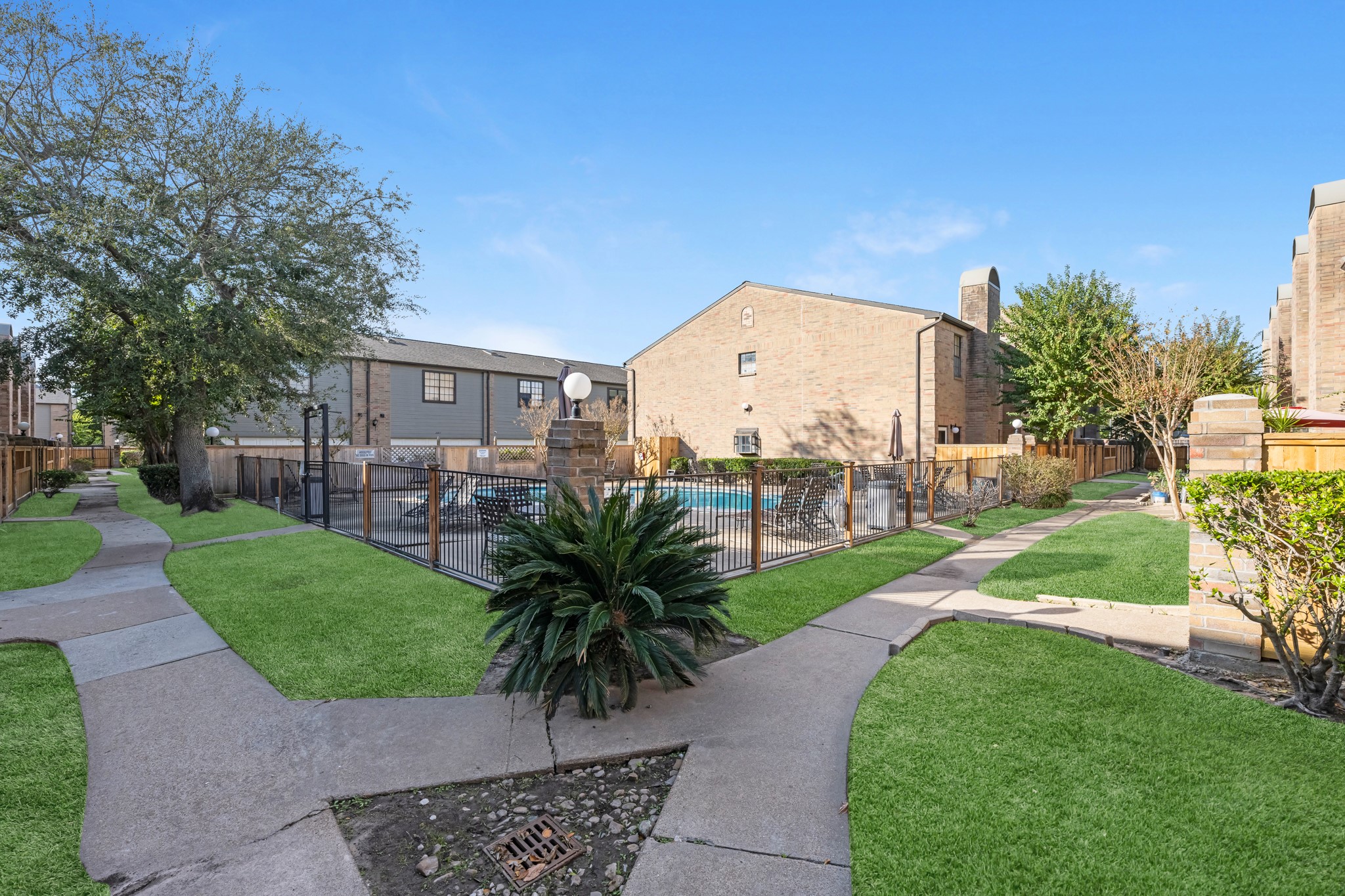 9800 Pagewood Lane, Unit 3103 Houston, TX 77063 - Photo 25 of 27 a view of a garden with a building in the background