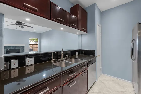 a kitchen with stainless steel appliances granite countertop a sink and a microwave