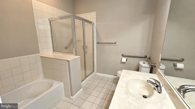 a bathroom with a tub a sink and mirror