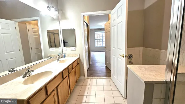 a bathroom with a tub sink and mirror