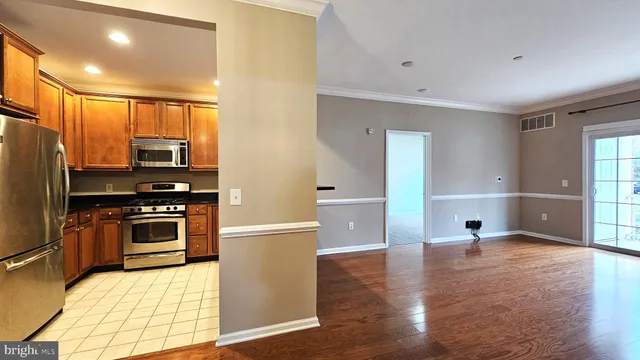 a kitchen with stainless steel appliances a stove a refrigerator and a sink