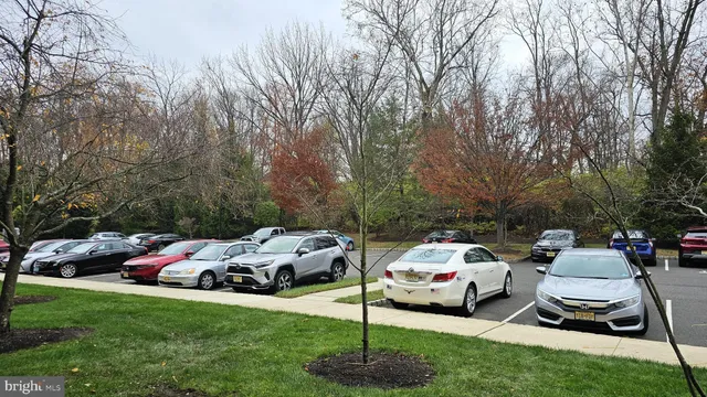 a car parked in front of a white house