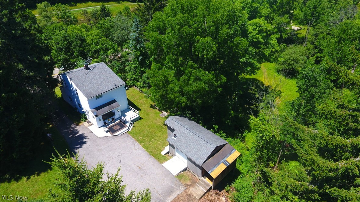 398 North Chillicothe Road Aurora, OH 44202 - Photo 38 of 39 Aerial property perspective featuring a white-sided residence with a dark gray shingled roof, accompanied by a detached structure with a matching roof