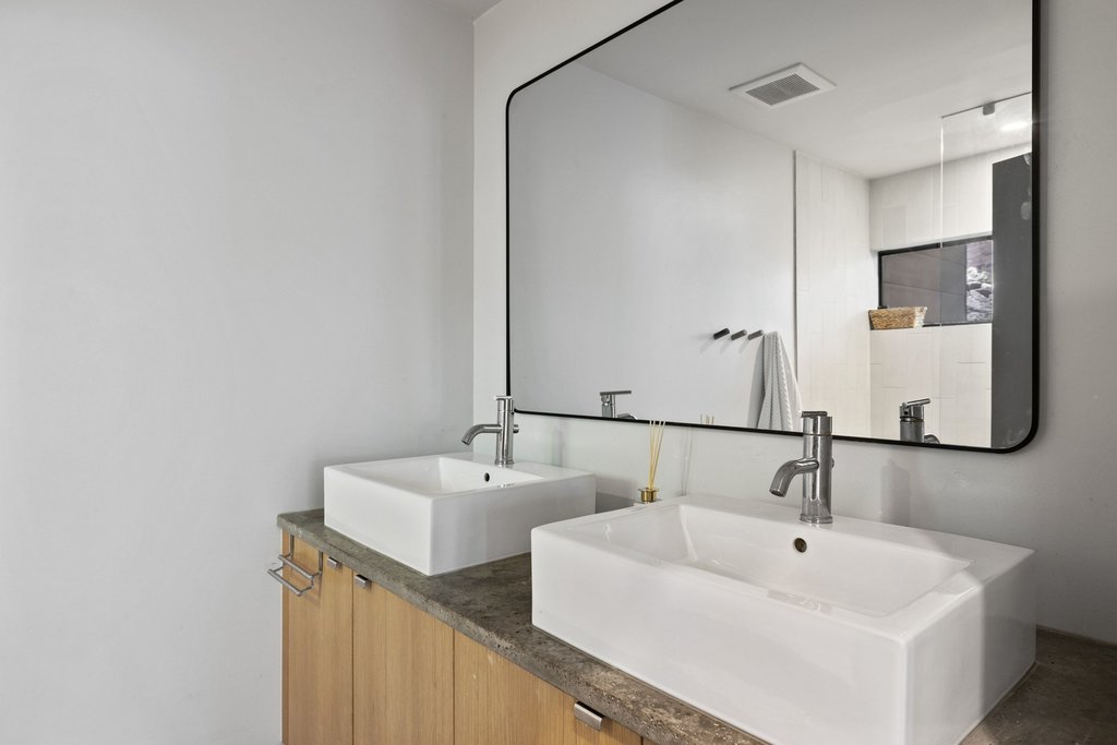 801 The High Road Austin, TX 78746 - Photo 30 of 40 a bathroom with 2 sink and a mirror