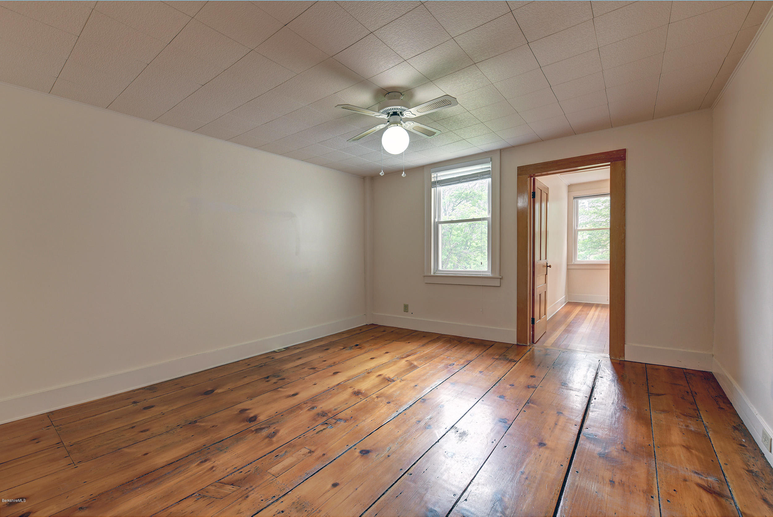 23 Glendale Road Stockbridge, MA 01262 - Photo 20 of 30 an empty room with wooden floor fan and windows
