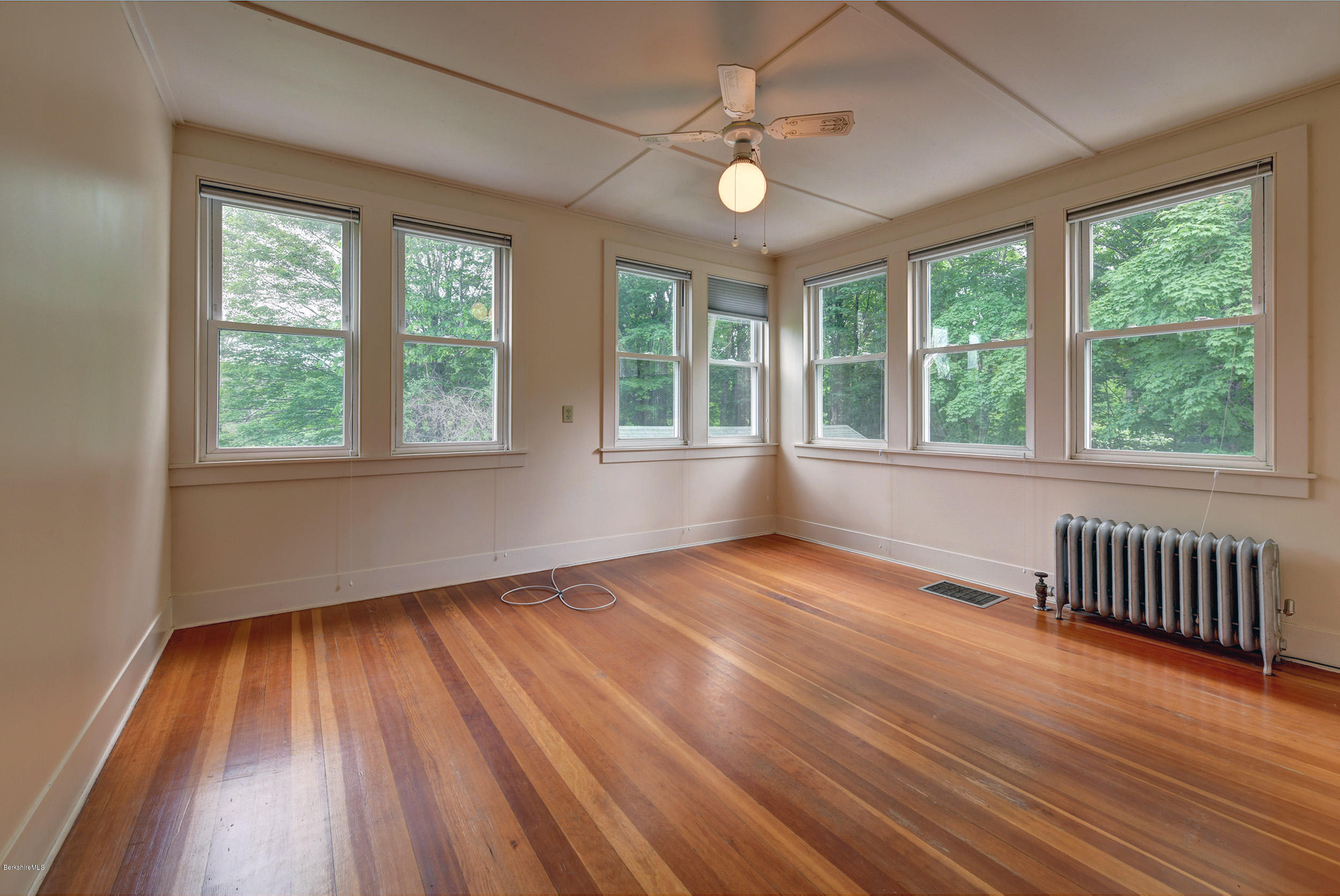 23 Glendale Road Stockbridge, MA 01262 - Photo 21 of 30 an empty room with wooden floor fan and windows