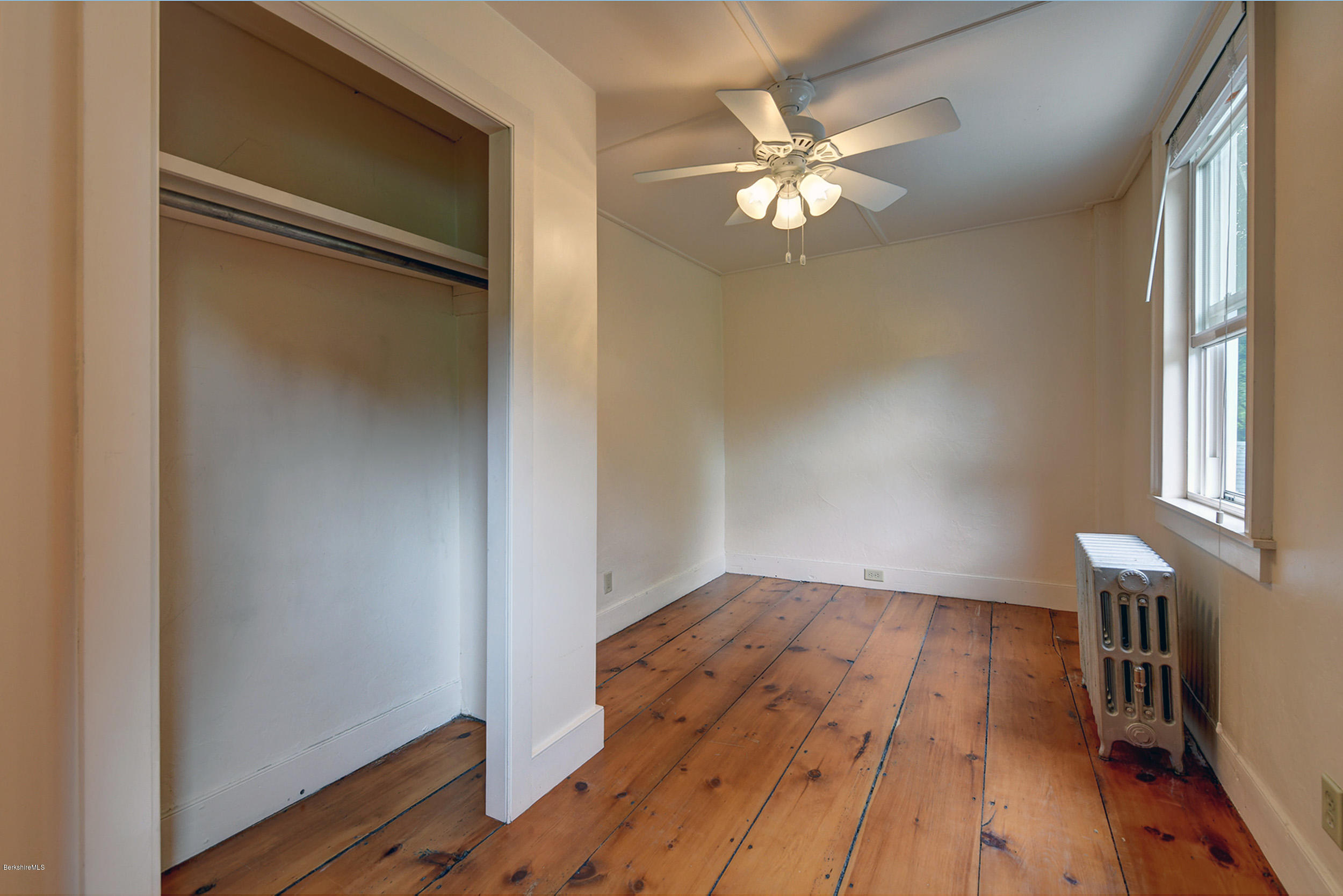 23 Glendale Road Stockbridge, MA 01262 - Photo 25 of 30 a view of empty room with wooden floor and fan