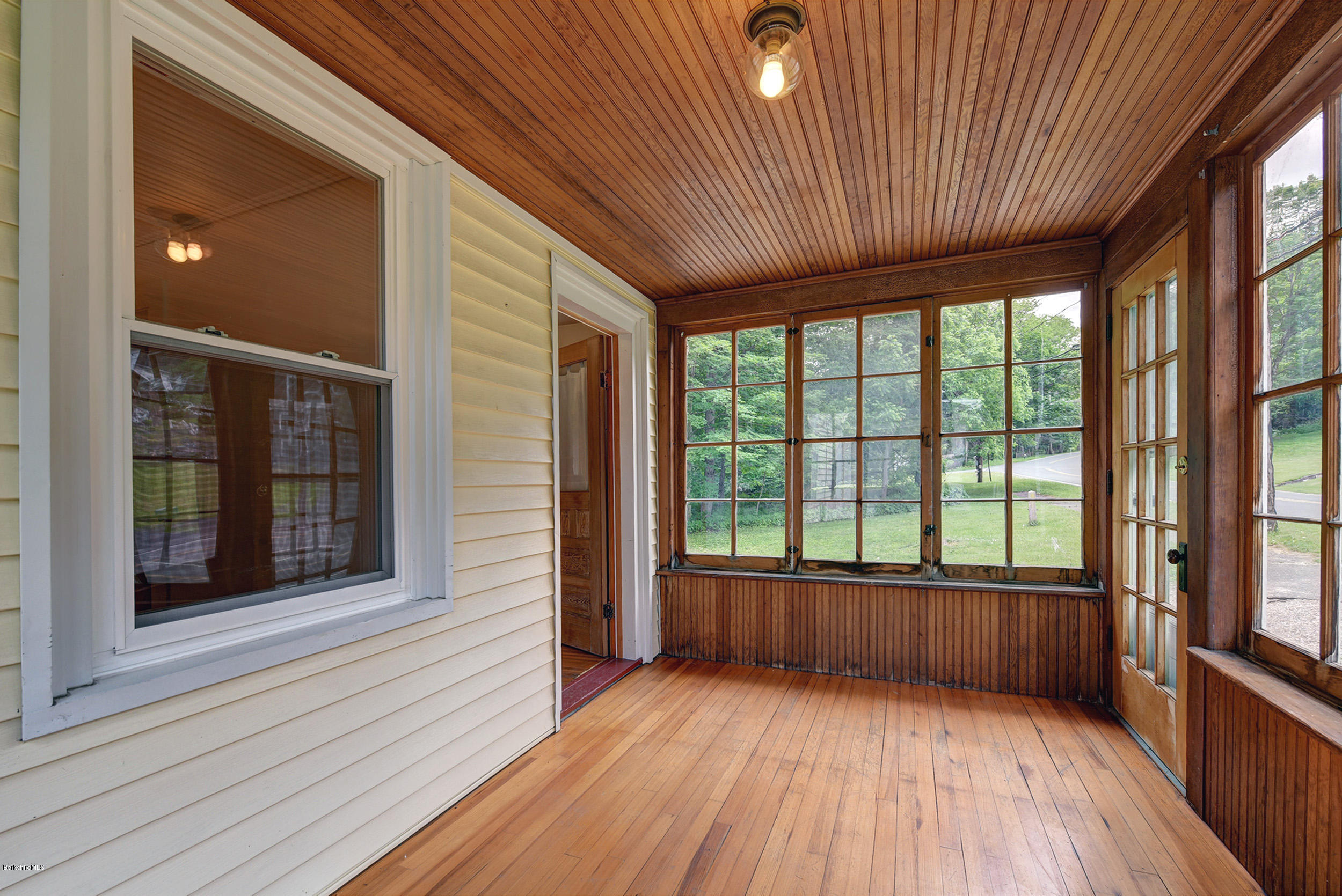 23 Glendale Road Stockbridge, MA 01262 - Photo 5 of 30 a view of a room with wooden floor and floor to ceiling windows