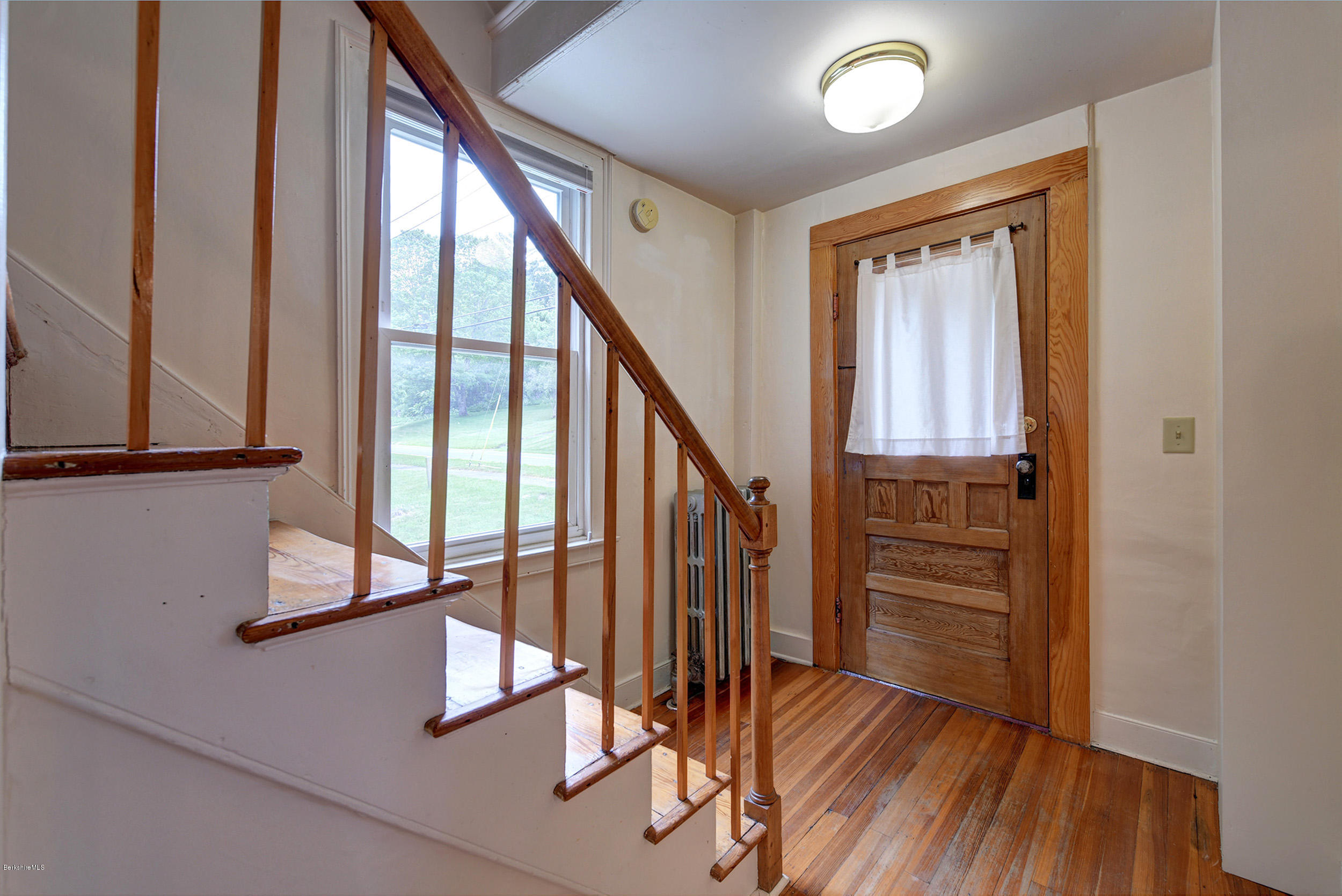 23 Glendale Road Stockbridge, MA 01262 - Photo 6 of 30 a view of front door with wooden floor and stairs