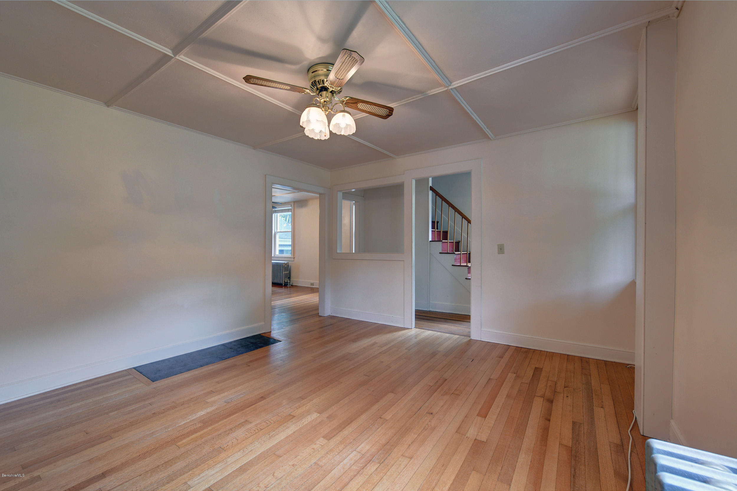 23 Glendale Road Stockbridge, MA 01262 - Photo 8 of 30 an empty room with wooden floor and ceiling fan